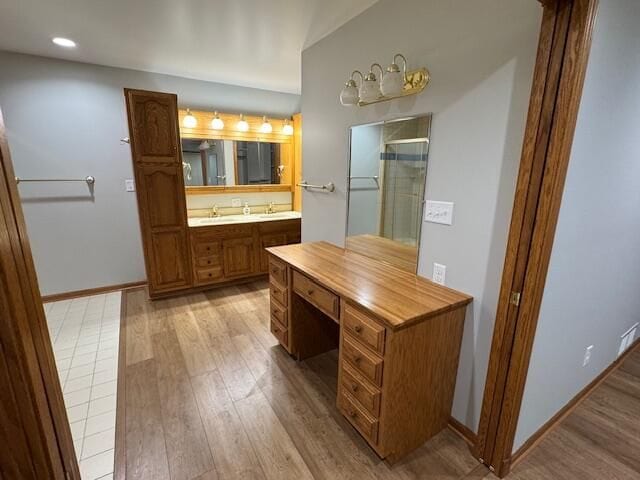 bathroom featuring vanity, an enclosed shower, and hardwood / wood-style floors