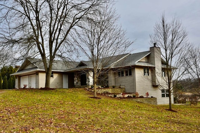 ranch-style house featuring a garage and a front lawn