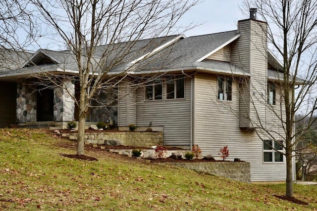 view of property exterior with a yard