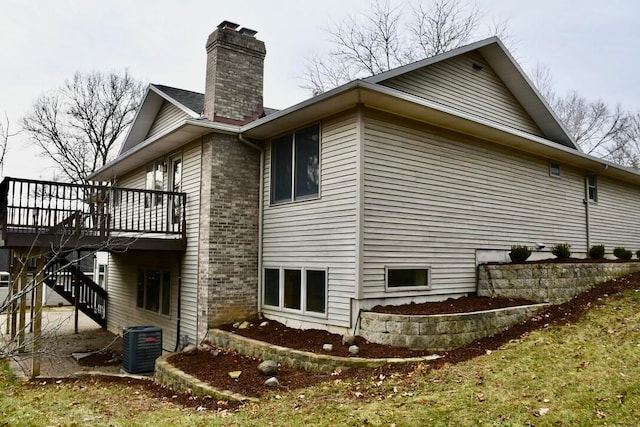 view of side of home featuring a wooden deck and central AC