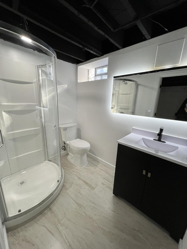 bathroom with vanity, toilet, and an enclosed shower