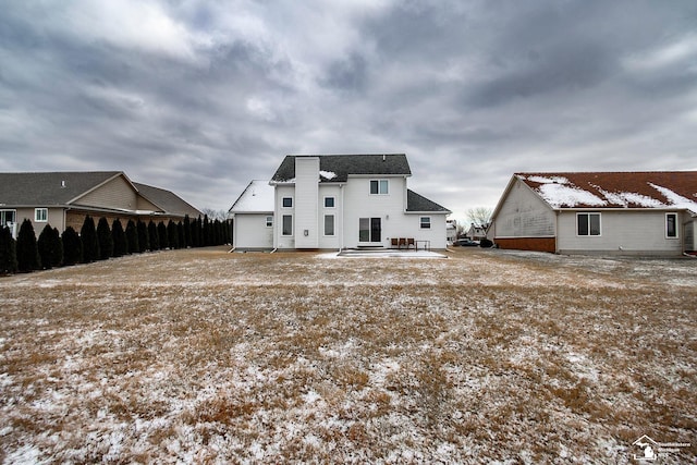 view of snow covered rear of property