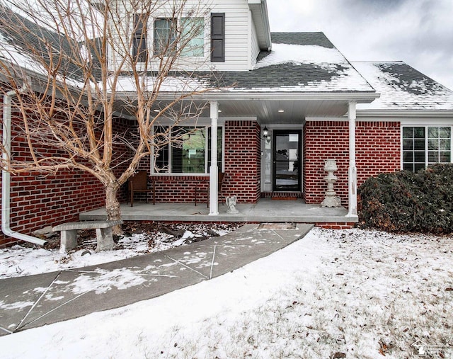 view of snow covered property entrance