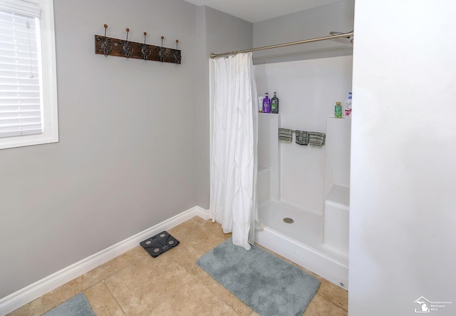 bathroom with tile patterned flooring and a shower with curtain