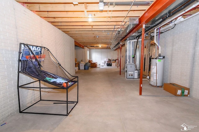 basement featuring brick wall, heating unit, and gas water heater