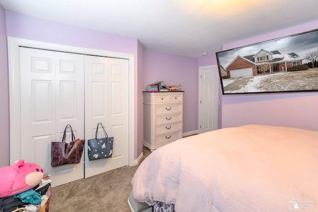 bedroom featuring light carpet and a closet