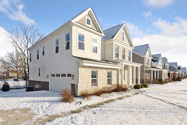 view of snow covered exterior with a garage