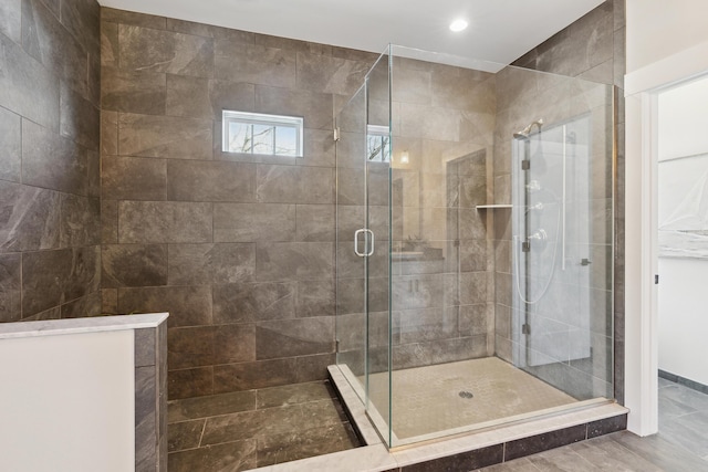 bathroom featuring a shower with shower door