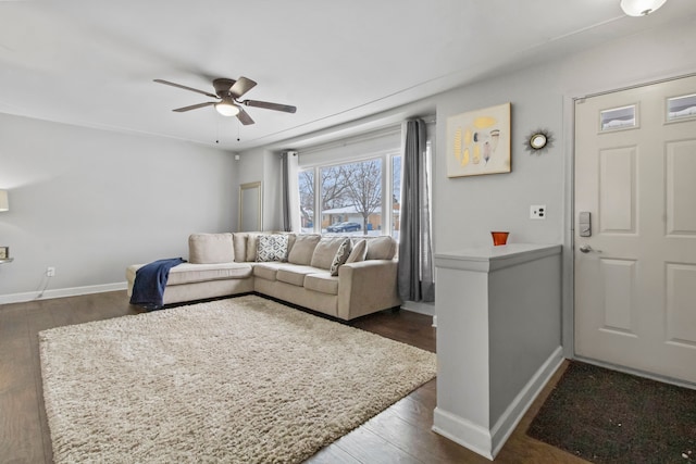 living room featuring ceiling fan and dark hardwood / wood-style flooring