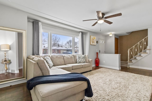 living room featuring ceiling fan and dark hardwood / wood-style flooring