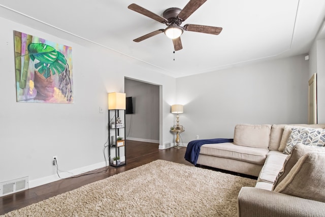 living room with dark hardwood / wood-style floors and ceiling fan