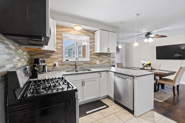 kitchen featuring sink, light tile patterned floors, white cabinets, and appliances with stainless steel finishes