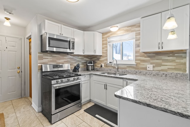 kitchen with white cabinetry, appliances with stainless steel finishes, light tile patterned flooring, and sink