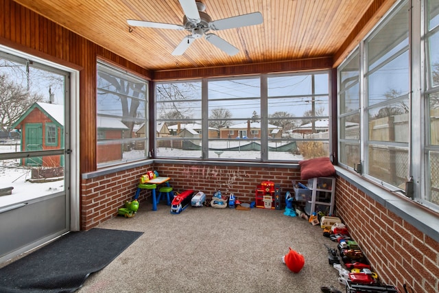 sunroom with ceiling fan and wood ceiling