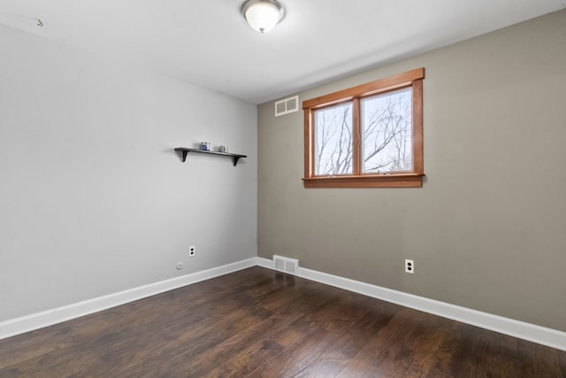 spare room with dark hardwood / wood-style flooring