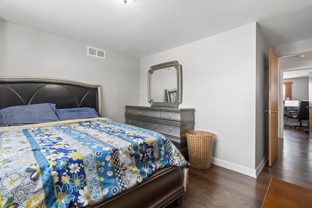 bedroom with dark hardwood / wood-style floors