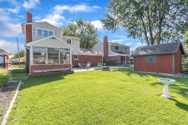 back of property with a shed, a yard, and a patio