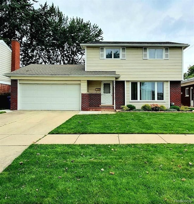 view of property with a garage and a front yard