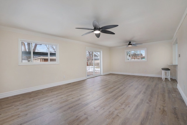 empty room with crown molding, ceiling fan, and light wood-type flooring