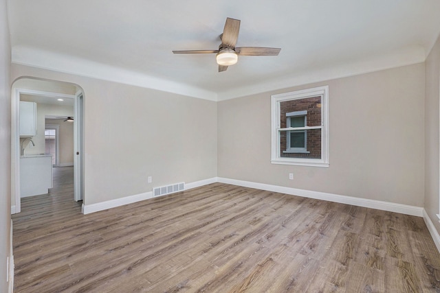 spare room featuring ceiling fan and light hardwood / wood-style flooring