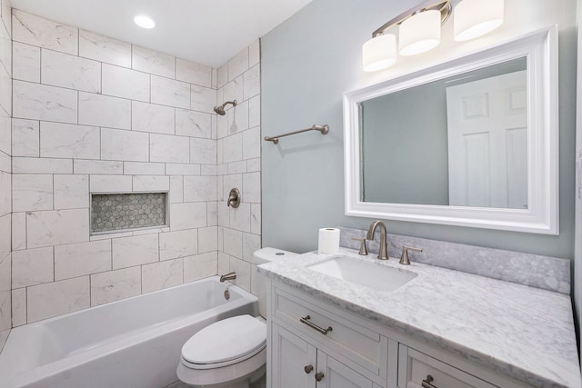 full bathroom with vanity, toilet, and tiled shower / bath combo