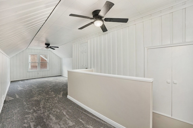 bonus room featuring lofted ceiling and dark colored carpet