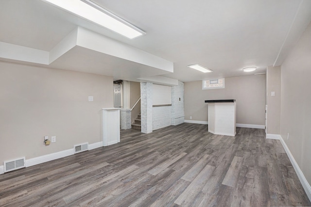 basement with dark hardwood / wood-style floors