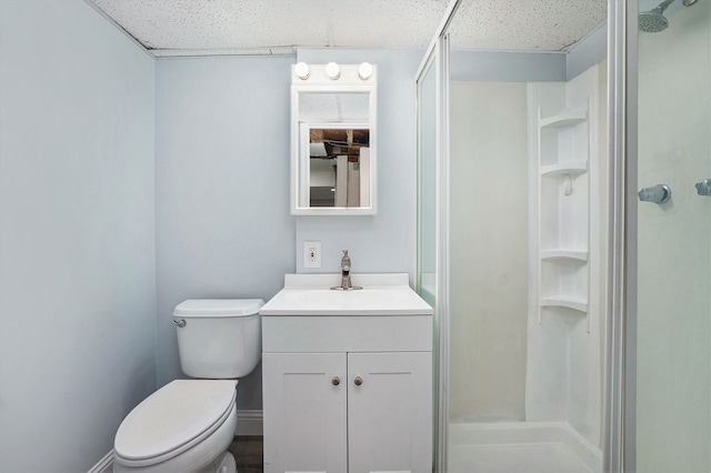 bathroom with vanity, toilet, and a shower