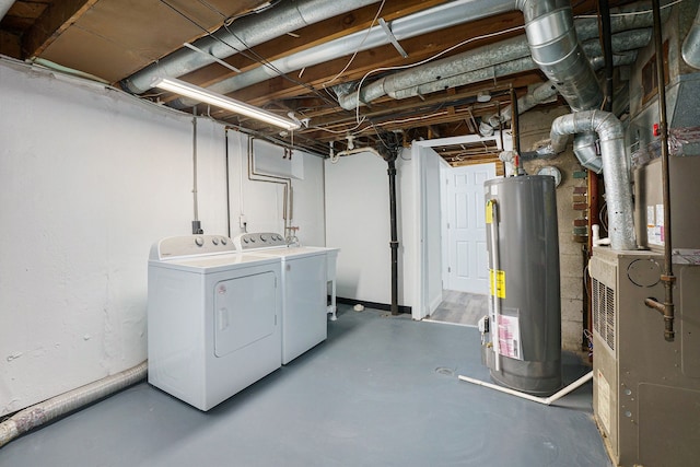 basement featuring heating unit, gas water heater, and independent washer and dryer