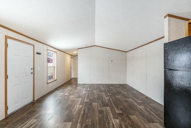 interior space featuring crown molding, dark wood-type flooring, and vaulted ceiling