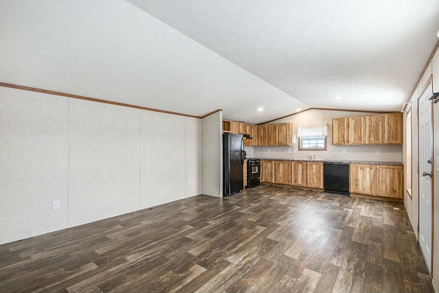 kitchen featuring dark hardwood / wood-style flooring, sink, black appliances, and lofted ceiling