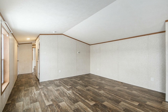 interior space featuring vaulted ceiling, dark hardwood / wood-style floors, and crown molding