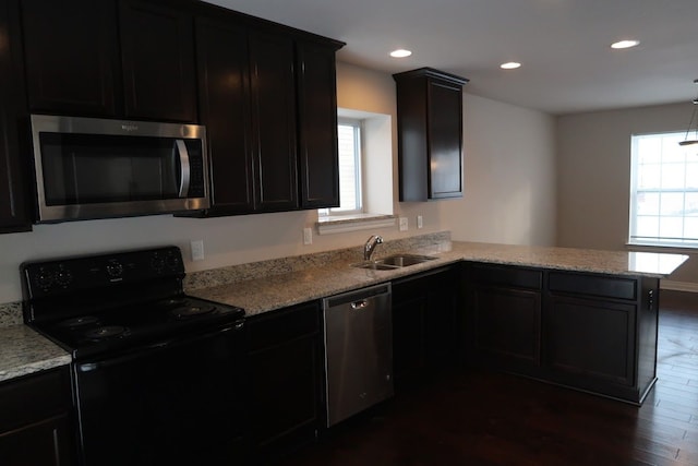 kitchen featuring a healthy amount of sunlight, appliances with stainless steel finishes, kitchen peninsula, and sink