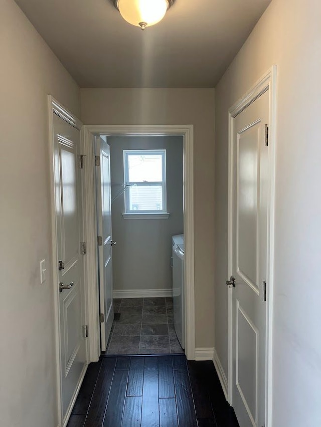 doorway to outside with washing machine and dryer and dark hardwood / wood-style floors