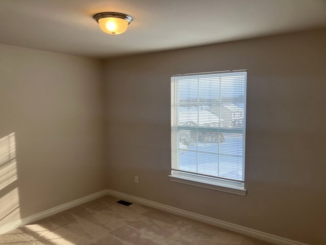 carpeted empty room featuring a healthy amount of sunlight