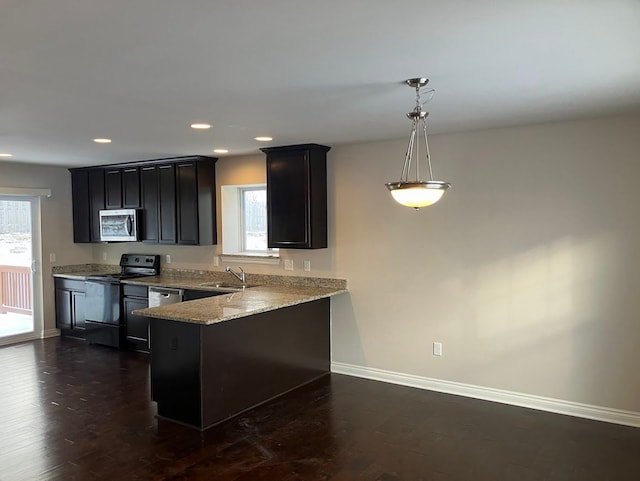 kitchen with sink, light stone counters, kitchen peninsula, pendant lighting, and black range with electric stovetop