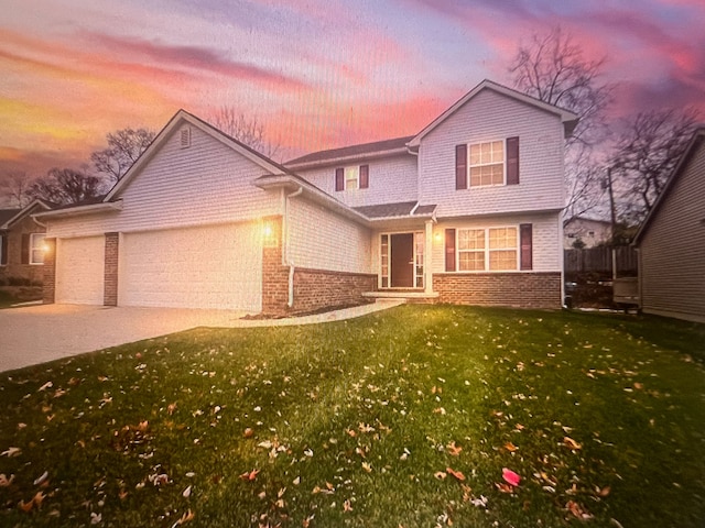 front of property featuring a garage and a yard