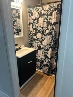 bathroom with vanity and hardwood / wood-style floors