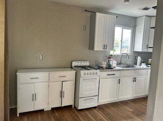 kitchen featuring white cabinetry, sink, white gas stove, and dark hardwood / wood-style flooring