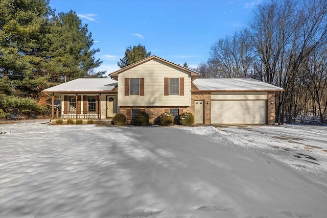 tri-level home with a garage and covered porch