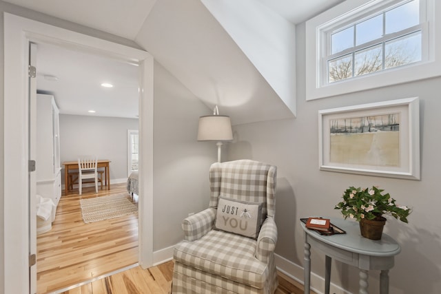 sitting room with light hardwood / wood-style flooring and vaulted ceiling