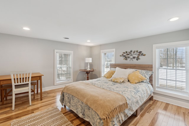 bedroom featuring hardwood / wood-style flooring and multiple windows