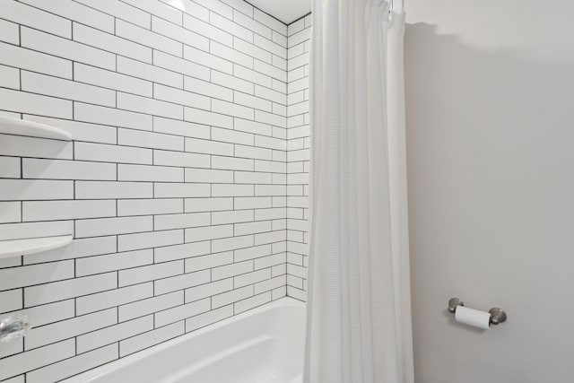 bathroom with shower / bath combination with curtain