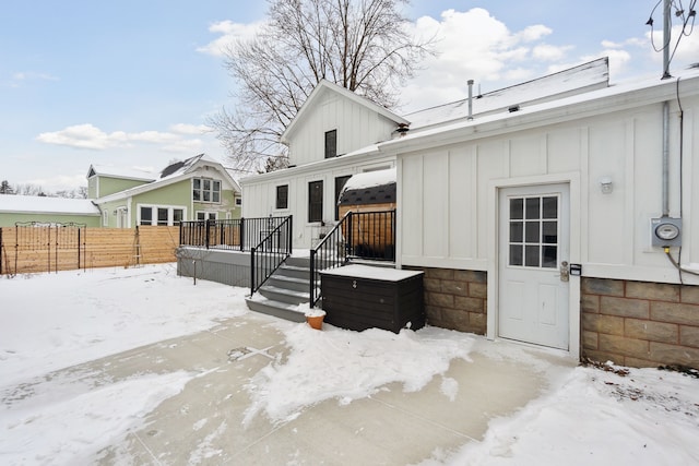 view of snow covered rear of property