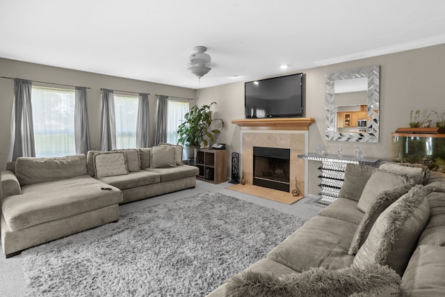 carpeted living room featuring a tile fireplace