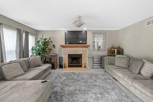 living room featuring a tile fireplace