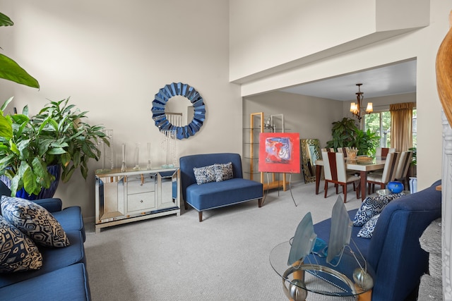 living room with an inviting chandelier and carpet flooring