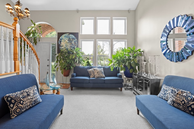 living room with carpet floors and a notable chandelier