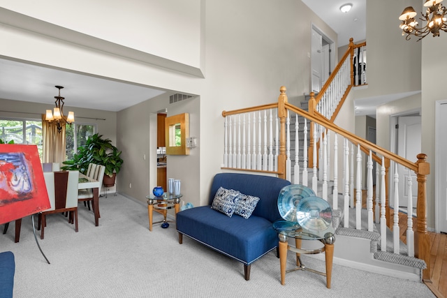 living area with carpet flooring and a notable chandelier