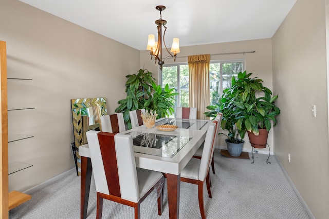 carpeted dining area featuring a chandelier